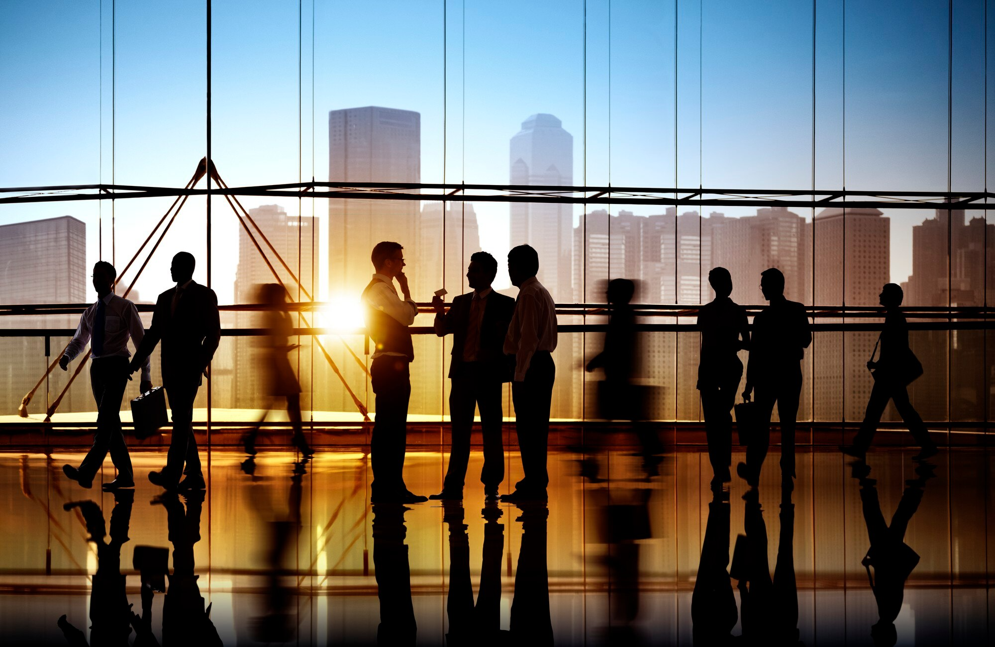 Team silhouettes in office building