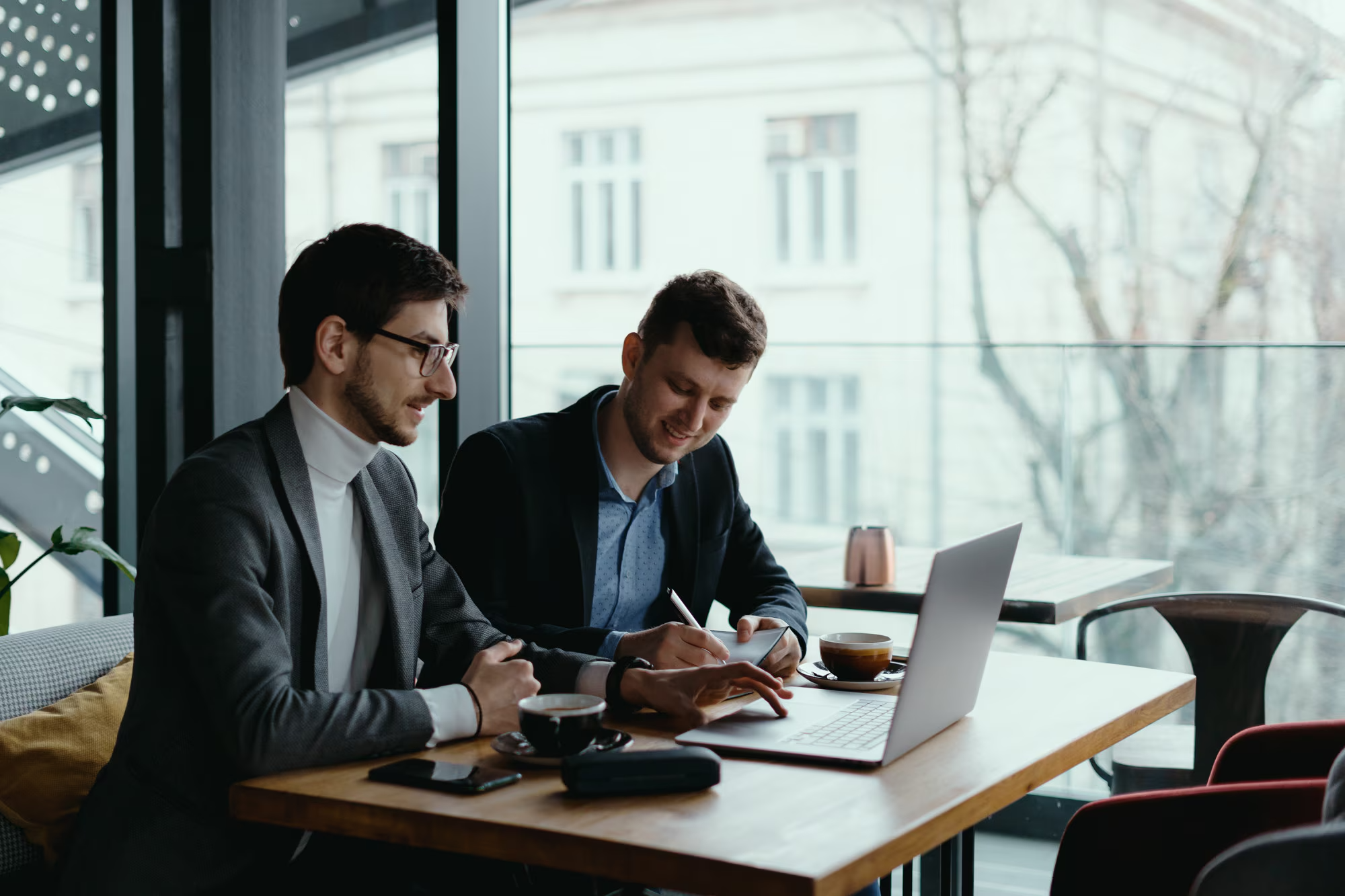 Business men working together on laptop